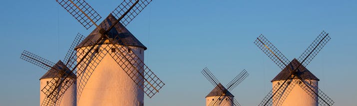Four white windmills in the sun in La Mancha