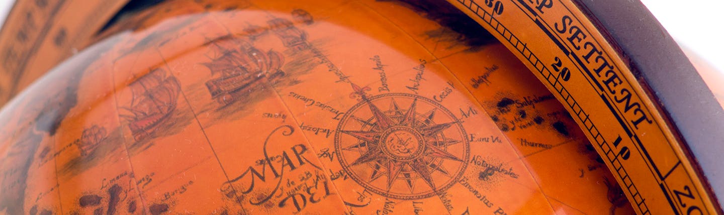 An antique orange-coloured globe showing map of the world