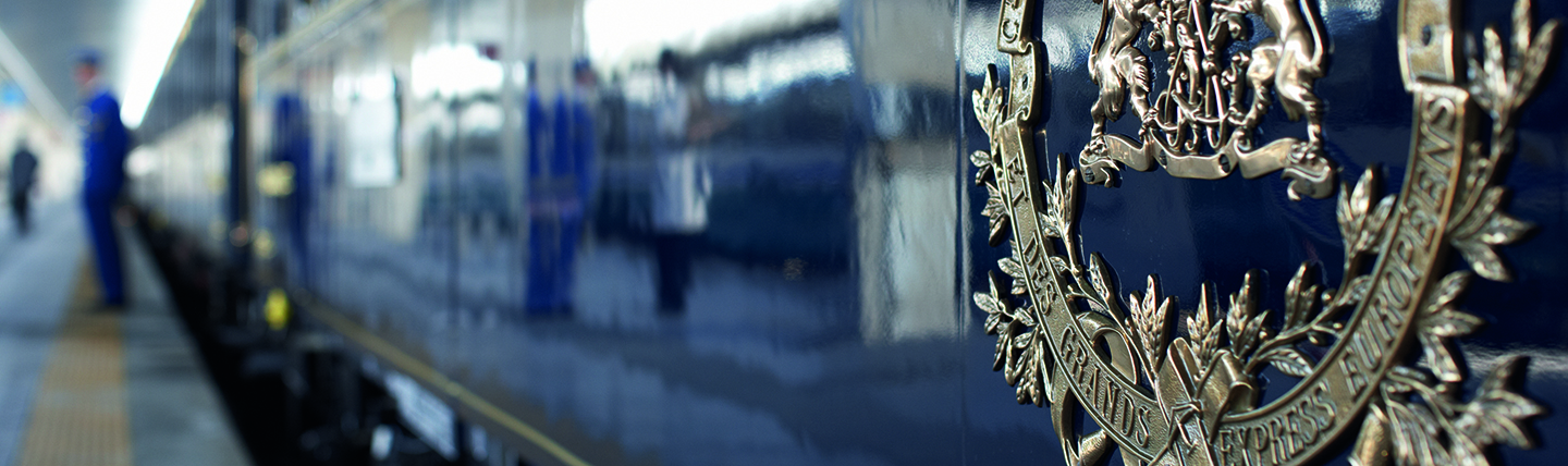 Silver embossed logo on side of the blue Orient Express train